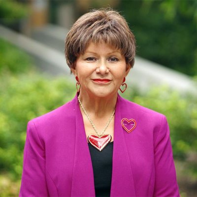 A woman wearing a pink blazer